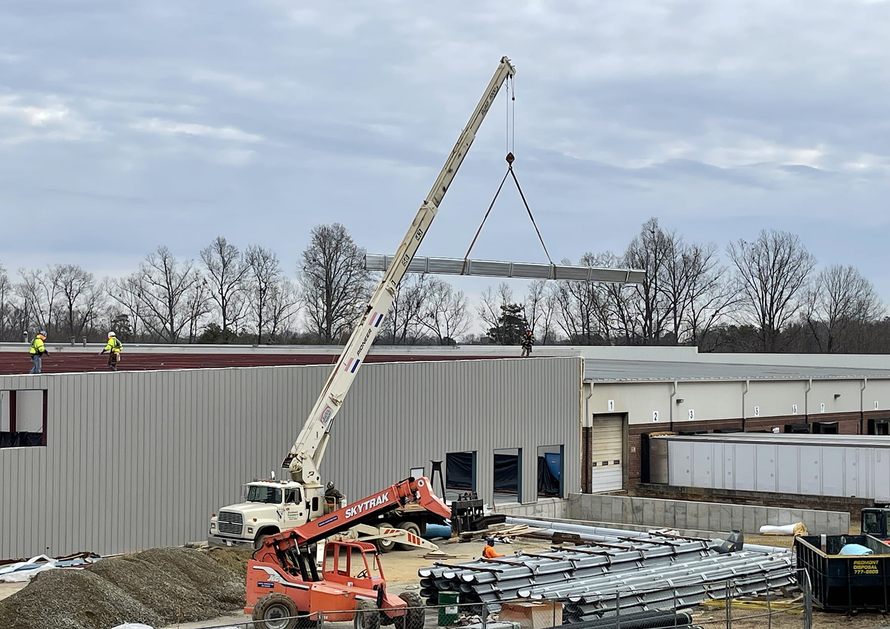 crane lifting roof components for Nordfab building addition