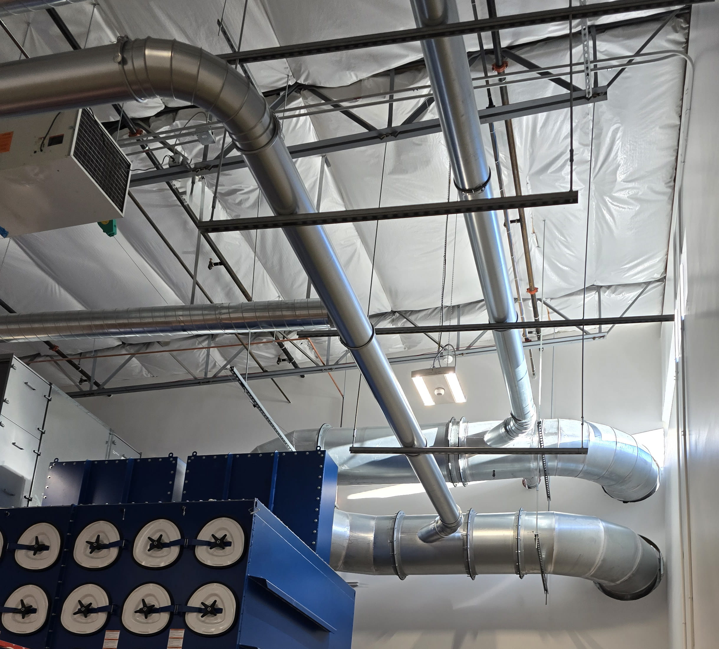 Nordfab ductwork connected to dust collector in ceramic products factory