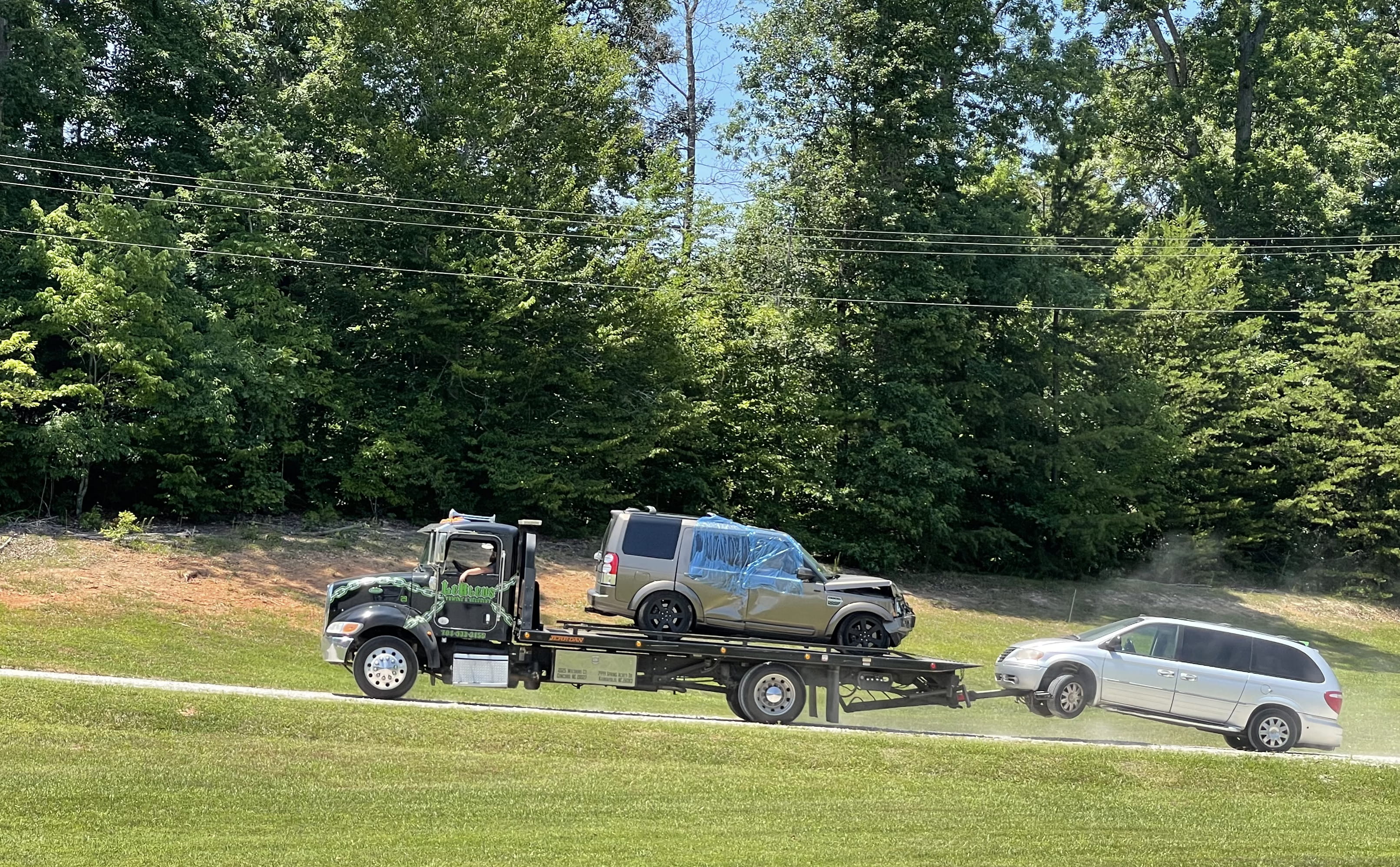 Nordfab's old work van is towed away for donation to a charity benefiting children's afterschool and summer programs
