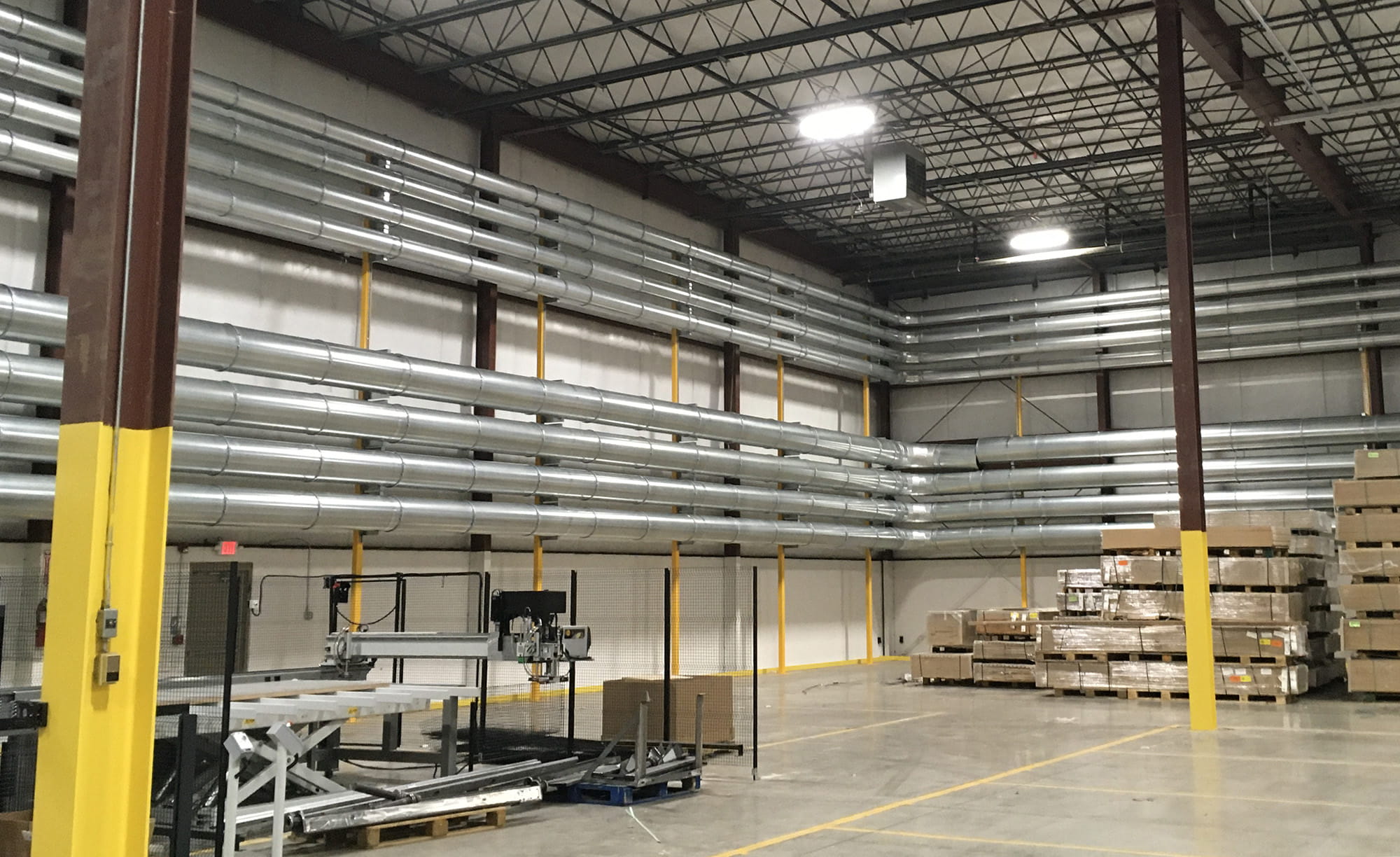 ten Nordfab Quick-Fit lines of ductwork mounted to cabinet factory wall