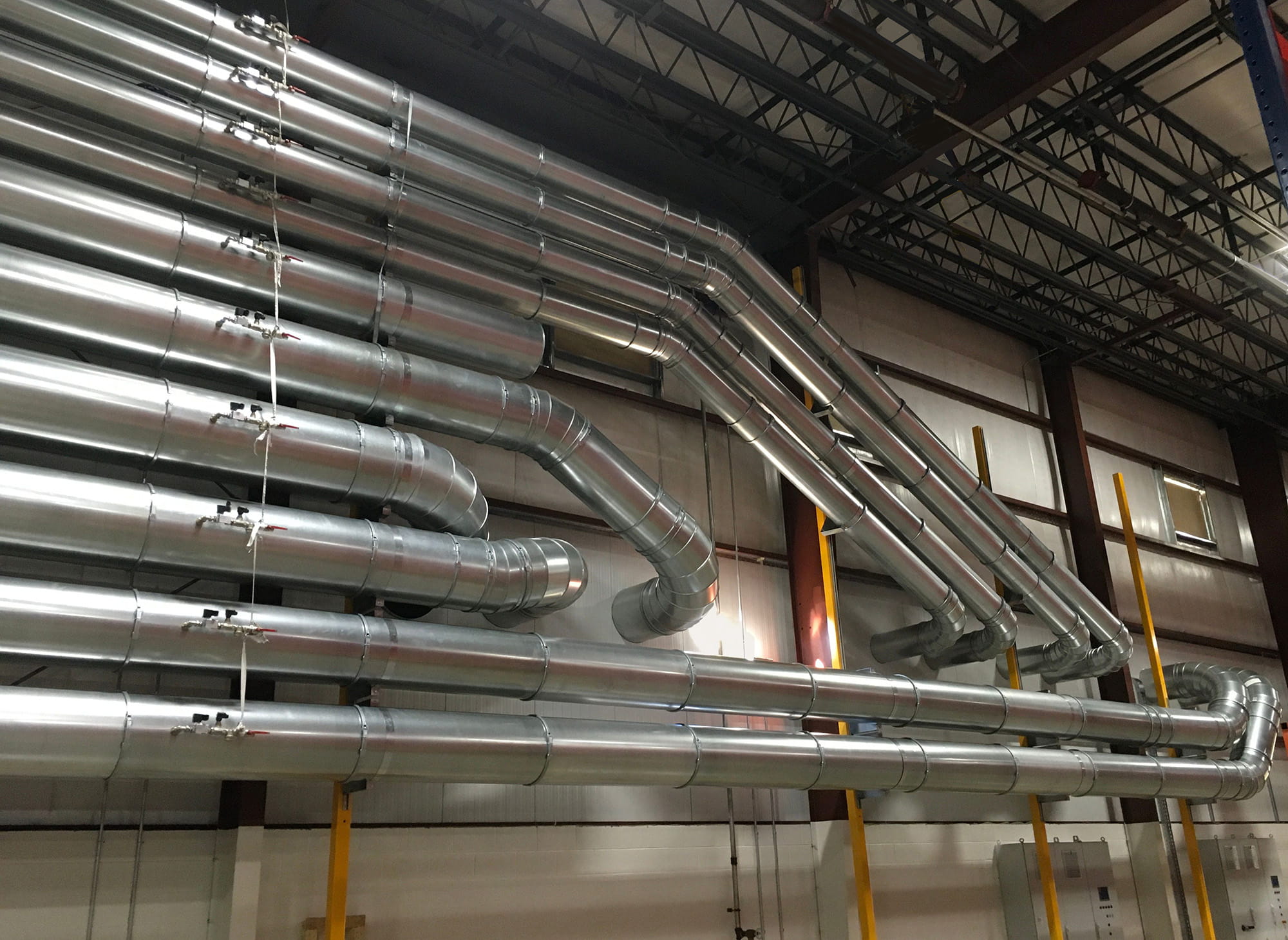 10 Nordfab duct lines mounted to wall in cabinet factory