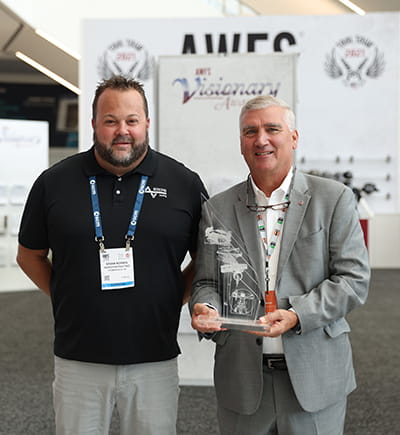 Nordfab Director of Sales Brian Norris with AWFS Board President Dan Hershberger at Visionary Award presentation