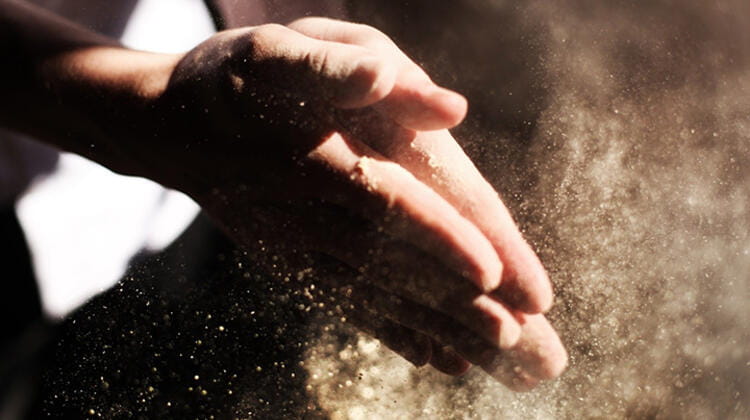 hands rubbing sawdust
