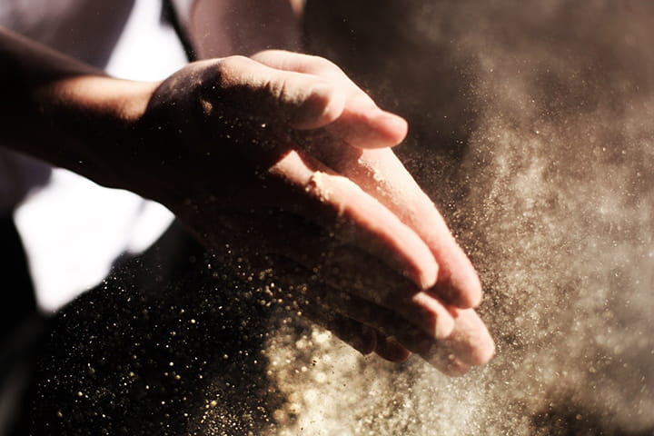 hands rubbing sawdust
