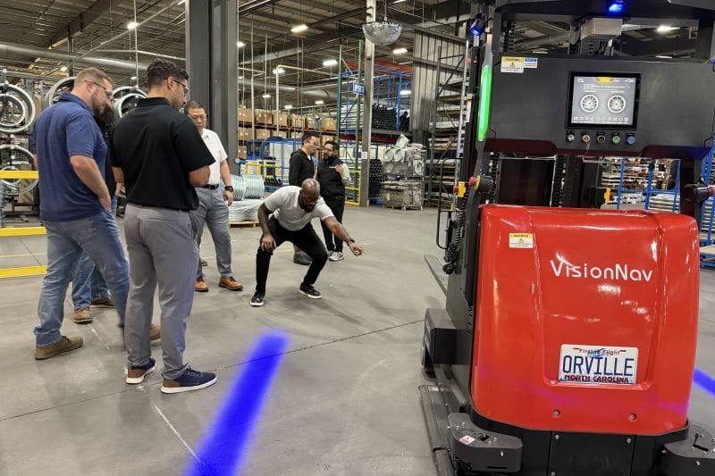 pointing to the forklift